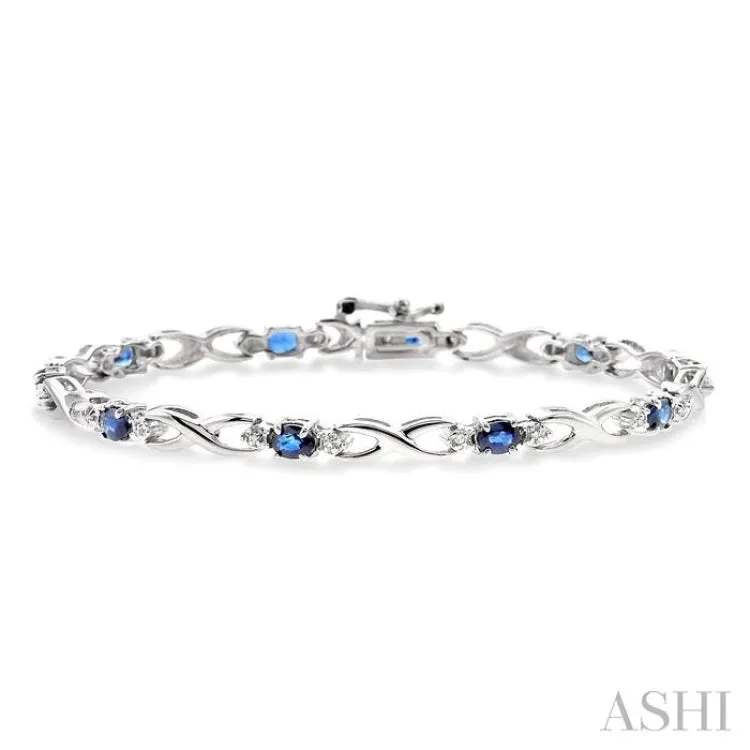 4x3mm Oval Cut Sapphire and 1/10 Ctw Single Cut Diamond Bracelet in 10K White Gold